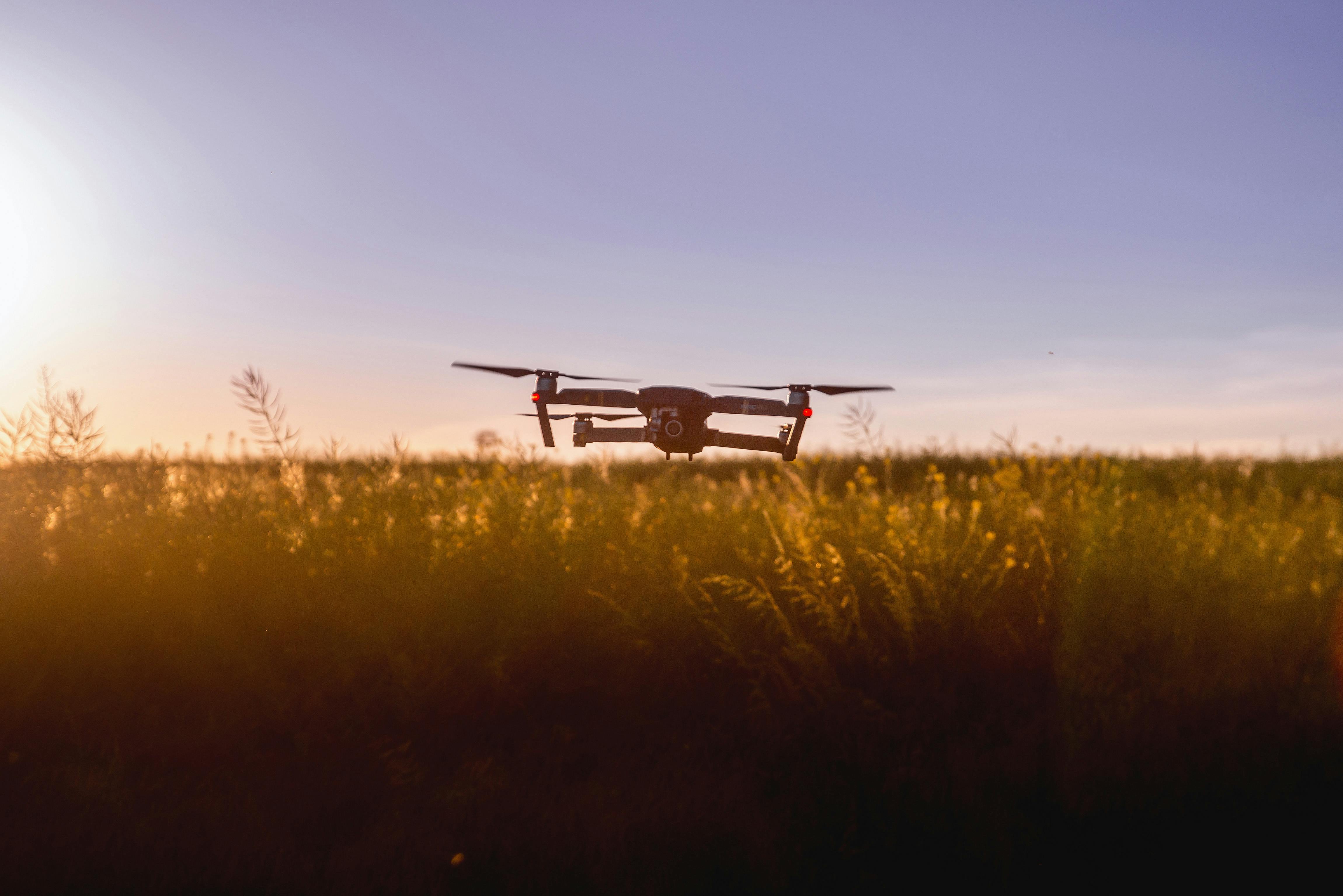 Hobbyist drone in an open field at sunset